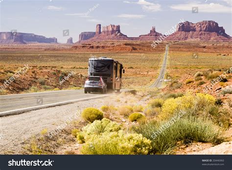 Recreational Vehicle Driving Through Monument Valley Stock Photo