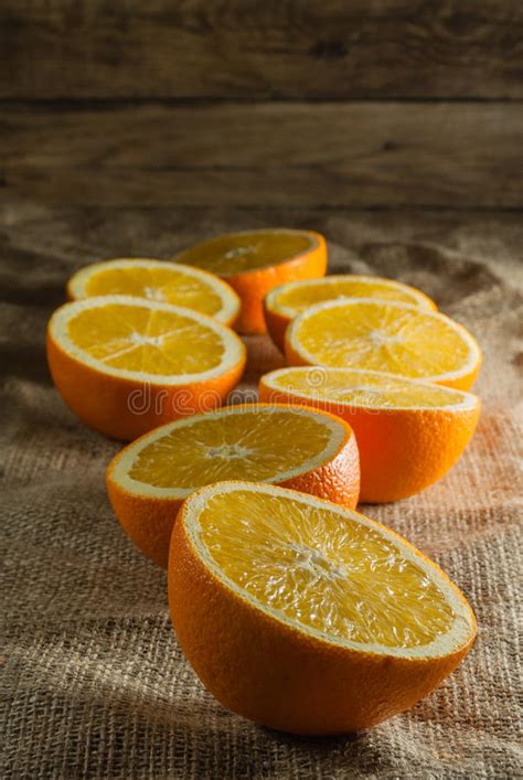 Oranges Fruits And Orange Slice On Wooden Table And Retro Fabric Stock