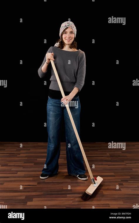 A Woman Holding A Broom Stock Photo Alamy