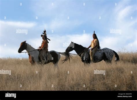 Two Native American Indian Men Sitting Bareback On A Horse In