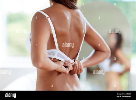 Woman Removing Her Bra Stock Photo Alamy