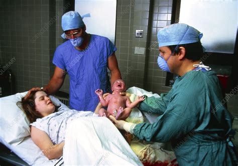 Childbirth Doctor Handing Newborn Baby To Mother Stock Image M810