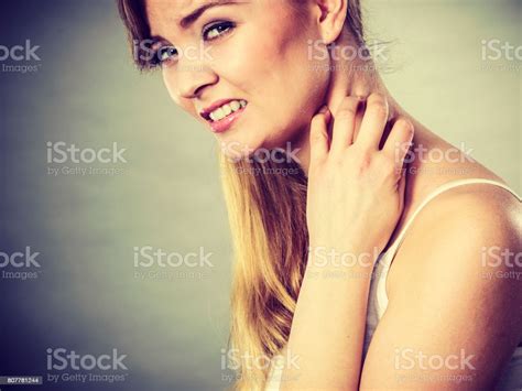 Woman Scratching Her Itchy Neck With Allergy Rash Stock Photo