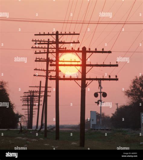 Telephone Poles And Railroad Signals At Sunset Stock Photo Alamy
