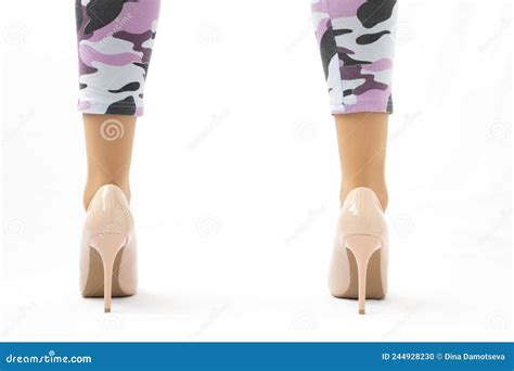 slender female legs elegant lacquered beige shoes with high heels leggings in camouflage stock