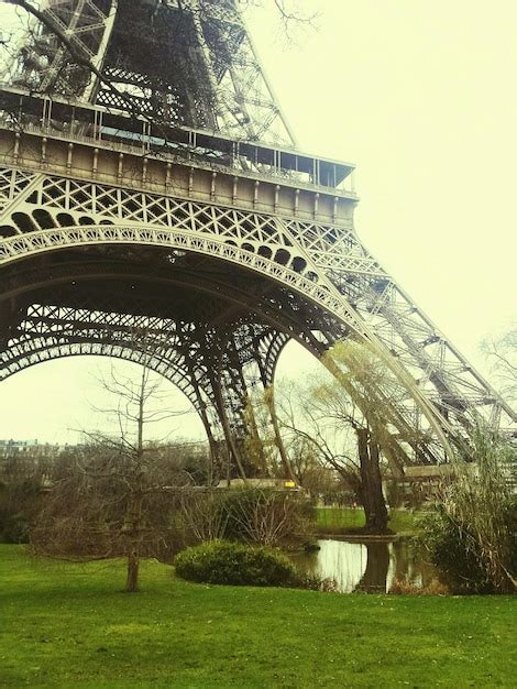 Premium Photo View Of Eiffel Tower On Grass Field