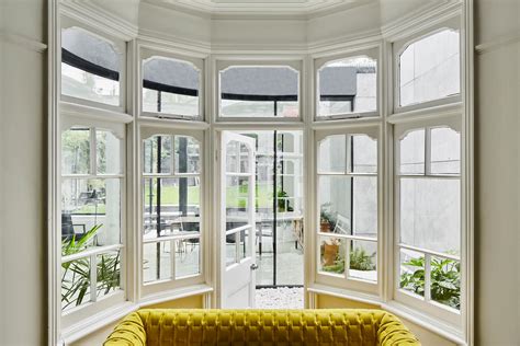 This Home Extension Wraps Around A Bay Window Creating A Small Courtyard