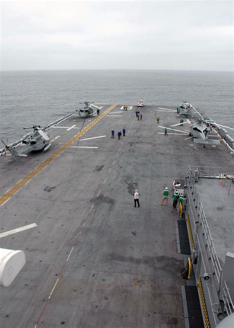 Us Navy Flight Deck Personnel Prepare To Launch A Uh 1 Yankee
