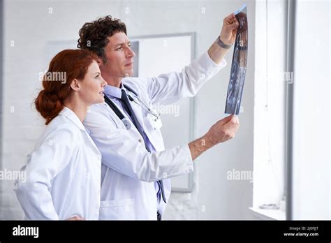 Learning Something New Everyday Shot Of Two Doctors Assessing A