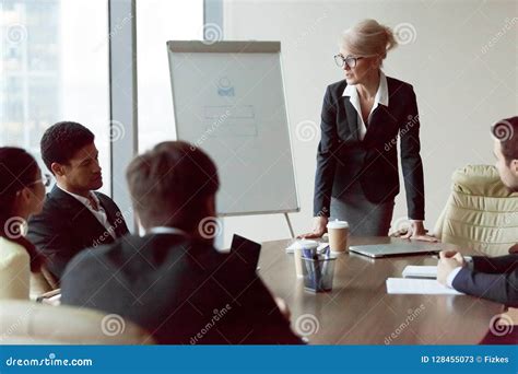 Serious Businesswoman Talk During Company Briefing In Office Stock