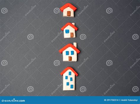 Houses Figurines in a Row. Find Most Suitable Housing Options Stock