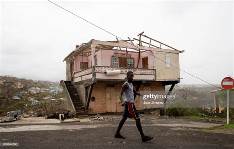 A Man Walks Past A Damaged House In Marigot Dominica On September News Photo Getty Images