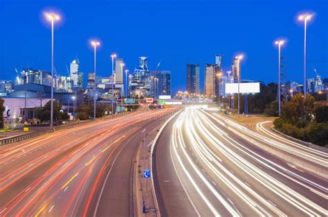 High Speed Traffic And Light Trails In Highway At Twilight Stock Photo