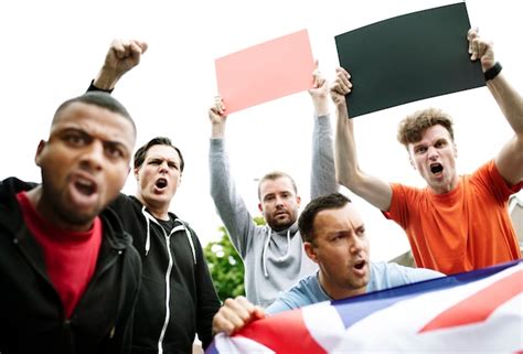 Premium Psd Group Of Angry Men Showing A Uk Flag And Blank Boards