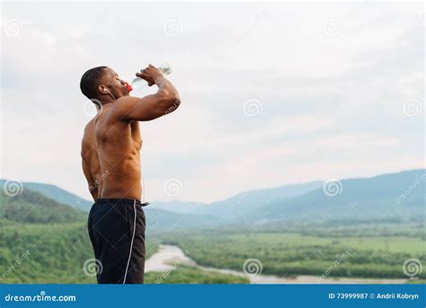 African American Muscular Man Drinking Water After Sports Training