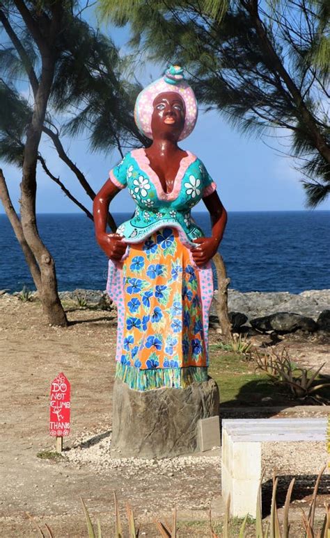 A Woman With Barbados Flag On Hygienic Mask In Her Hand And Lifted Up