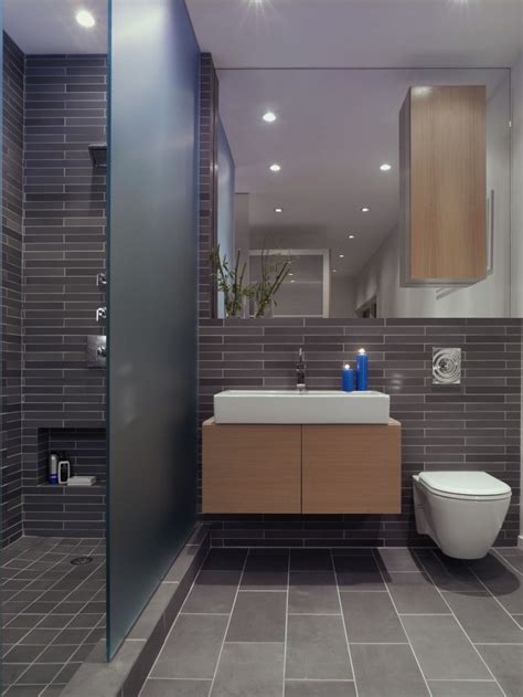 In this breathtakingly beautiful bathroom, large format porcelain tiles seamlessly flow from the bath to the bedroom, with matching mosaics adding a lasting impression. 25 grey wall tiles for bathroom ideas and pictures