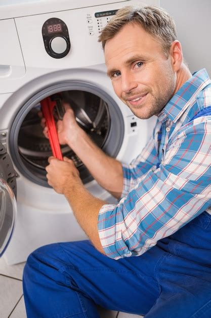 Premium Photo Handyman Fixing A Washing Machine