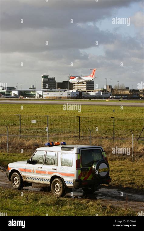 Police Patrolling The Outer Ring Perimeter Fence At Manchester Airport