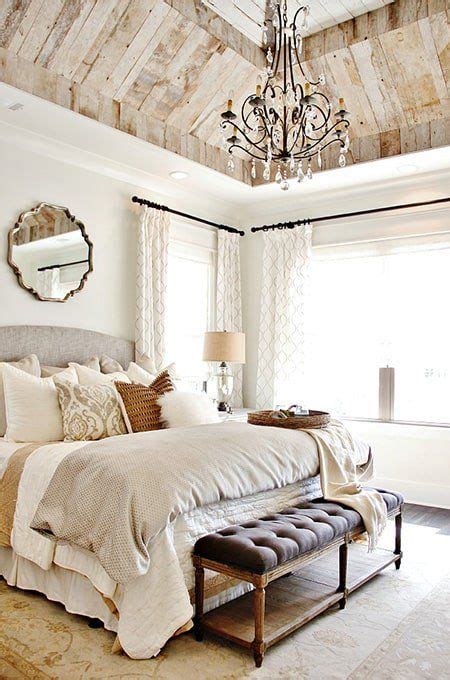 A Bedroom With A Large Bed And A Chandelier Hanging From Its Ceiling