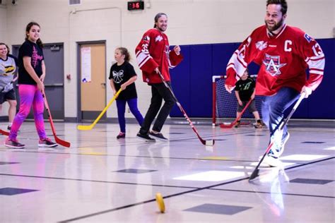 Americans Players And Broadcaster Participate In Floor Hockey Game In