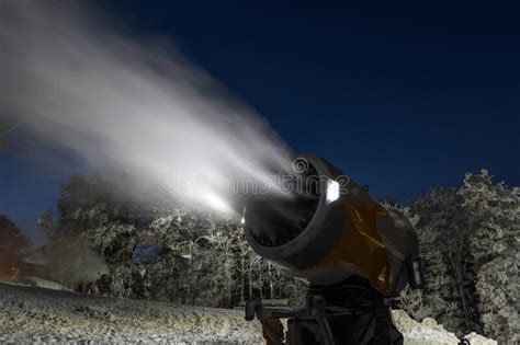 Night Photo Of Snow Cannon Or Snowmaking Machine In Action In Ski