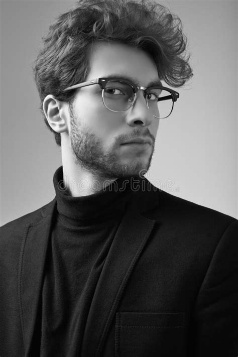 Handsome Elegant Man With Curly Hair Wearing Suit And Glasses Stock