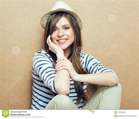 Woman Sitting In Front Of Wooden Wall Stock Photo Image Of