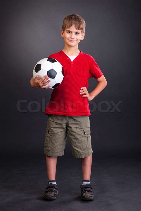 Cute Boy Is Holding A Football Ball Soccer Ball Stock Image Colourbox