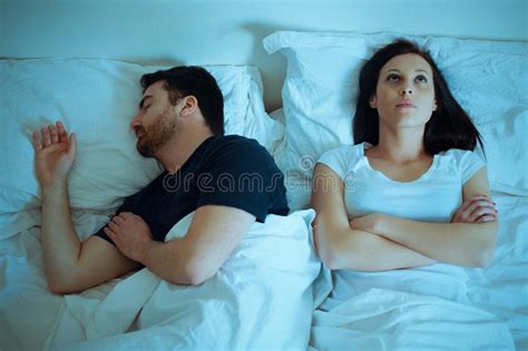 Sad And Thoughtful Woman Awake While Husband Is Sleeping In Bed Stock Image Image Of