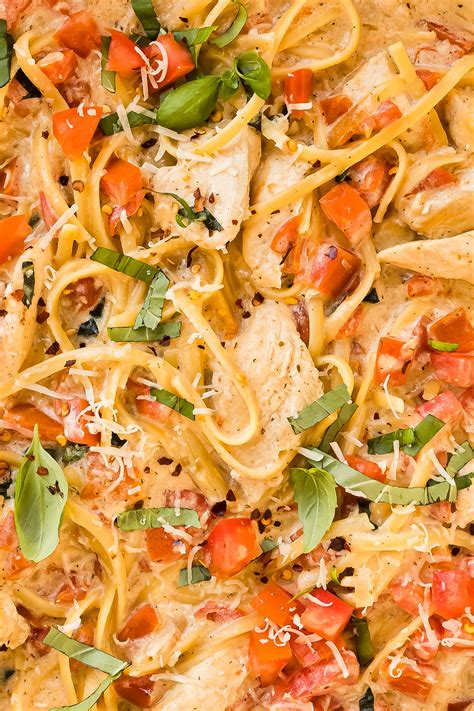Overhead Close Up Photo Of Chicken Linguine Tomatoes And Basil In