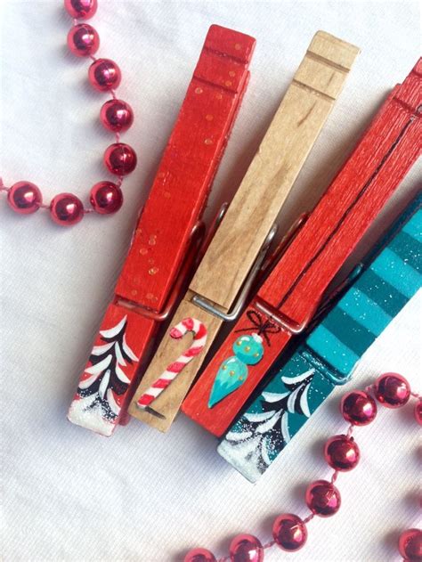 Some Red And Blue Wooden Clothes Pins On A White Table With Bead Necklaces