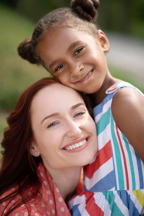 Close Up Of Mother And Daughter Feeling Happy Together Stock Photo