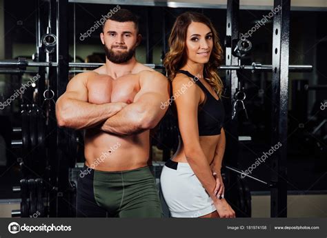 Young Sexy Beautiful Fitness Couple Is Exercising In The Gym The Instructor Is Exercising