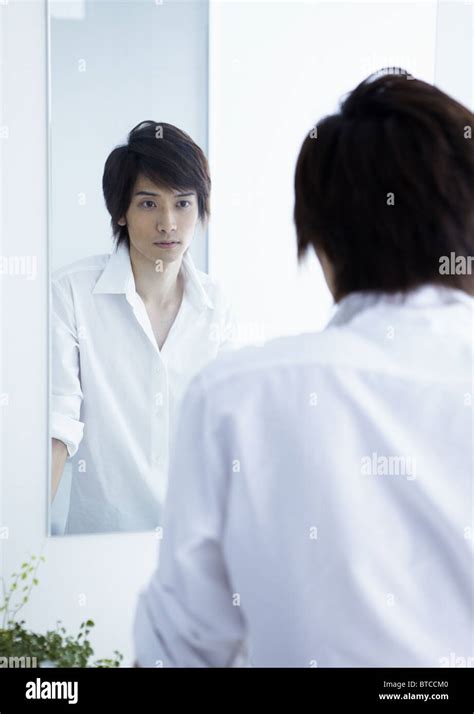 Young Man Looking In Mirror Stock Photo Alamy