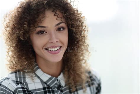 Portrait Of A Beautiful Young Woman With Curly Hair Stock Photo