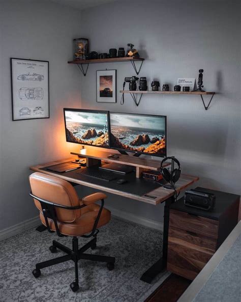 A Computer Desk With Two Monitors On Top Of It And A Chair Next To It
