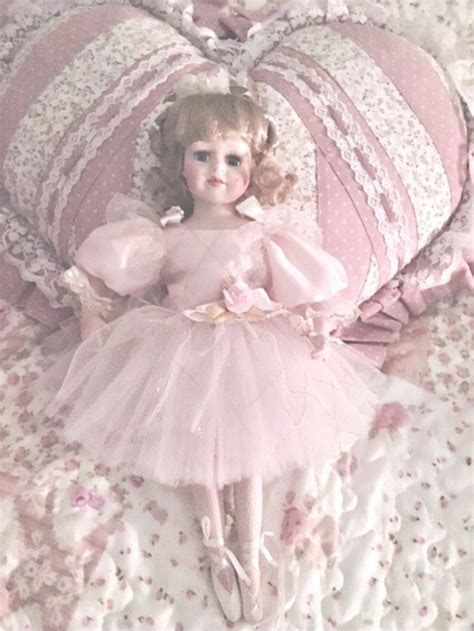 A Doll Laying On Top Of A Bed Next To Pillows And Pillow Covers With
