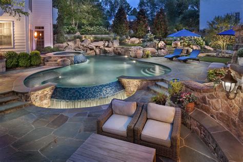 Infinity Edge Pool With Boulder Waterfall And Spa Backyard Pool