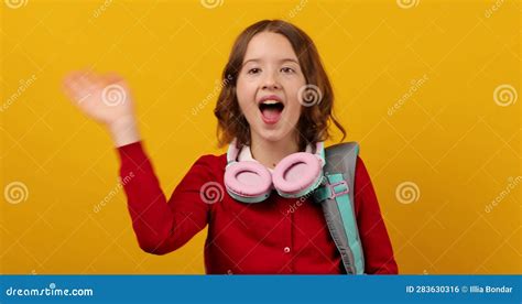 Stylish School Teenage Girl In Headphone With A Backpack On Her