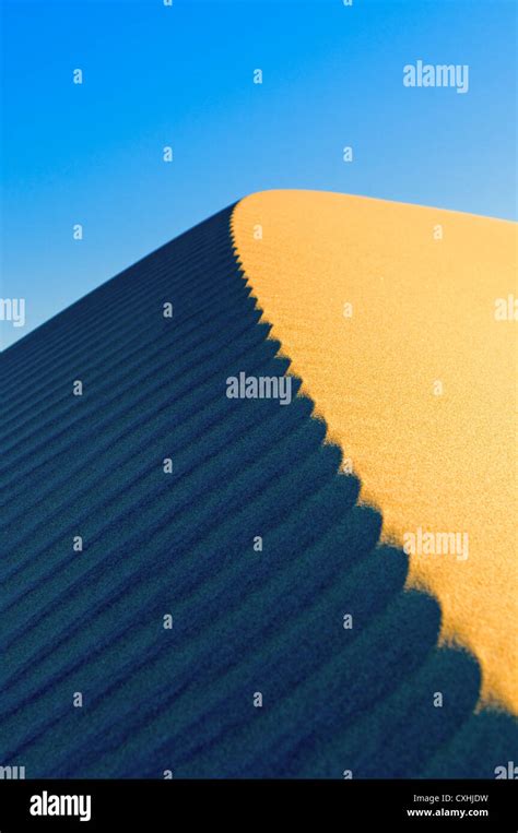 Sand Dunes Over Blue Sky Stock Photo Alamy