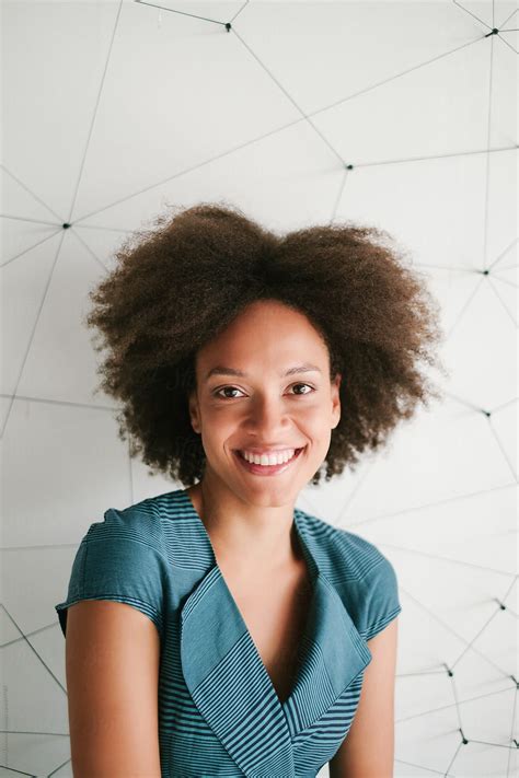 portrait of beautiful smiling woman with afro hairstyle by stocksy contributor brkati