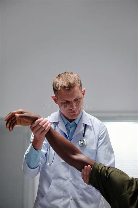 Doctor Examining The Arm Of Patient Stock Photo Image Of Army Hand