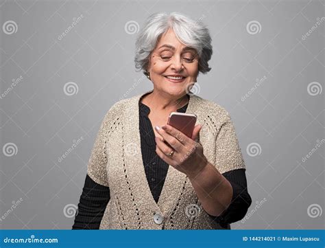 Smiling Senior Female Looking At Smartphone Stock Image Image Of