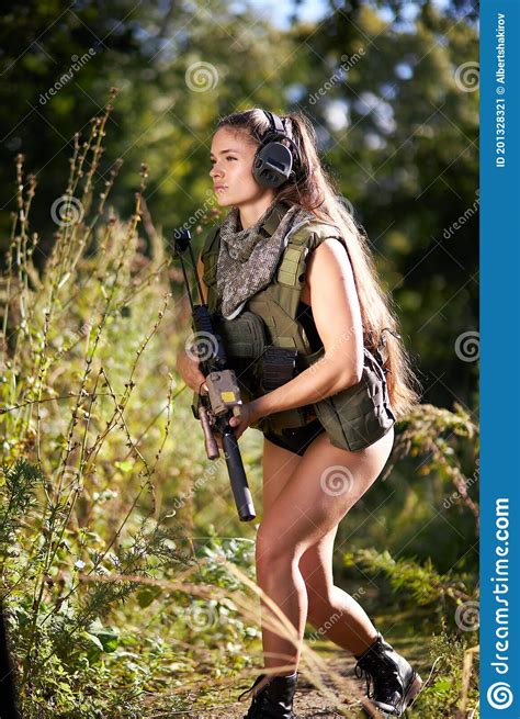 Female Hunter In Camouflage Waiting For Opportunities To Shoot Stock