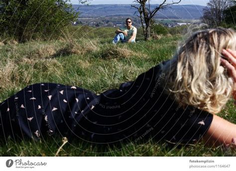 Couple Lying Opposite Each Other In The Grass A Royalty Free Stock