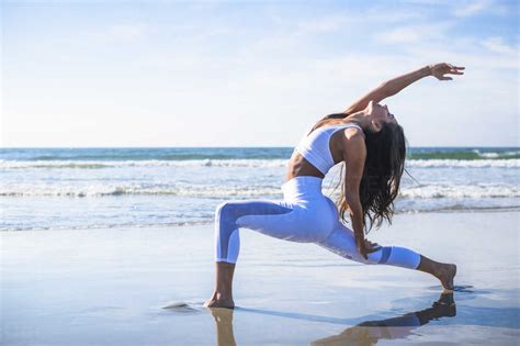 Woman Doing Yoga On Beach Stock Photo