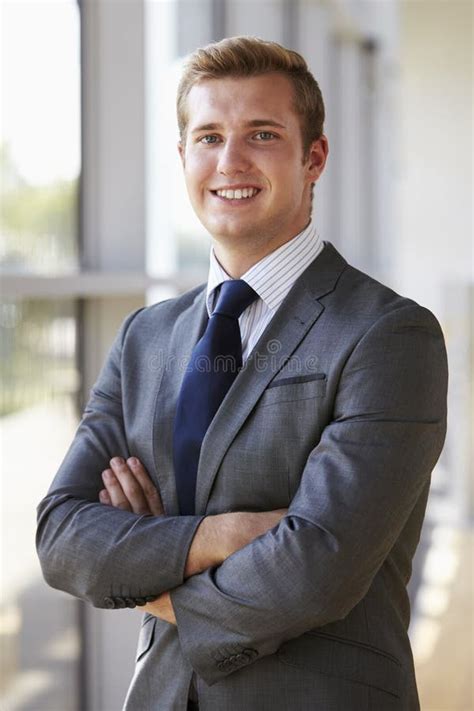 Portrait Of A Young Smiling Professional Man Arms Crossed Stock Image