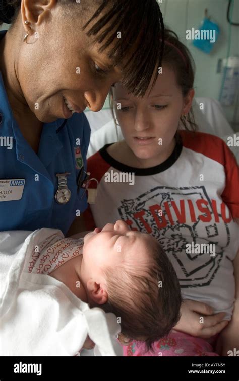 Midwife With New Mum And Her Baby Stock Photo Alamy