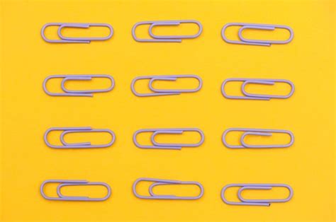 Premium Photo Purple Paper Clips On Yellow Background Flat Lay